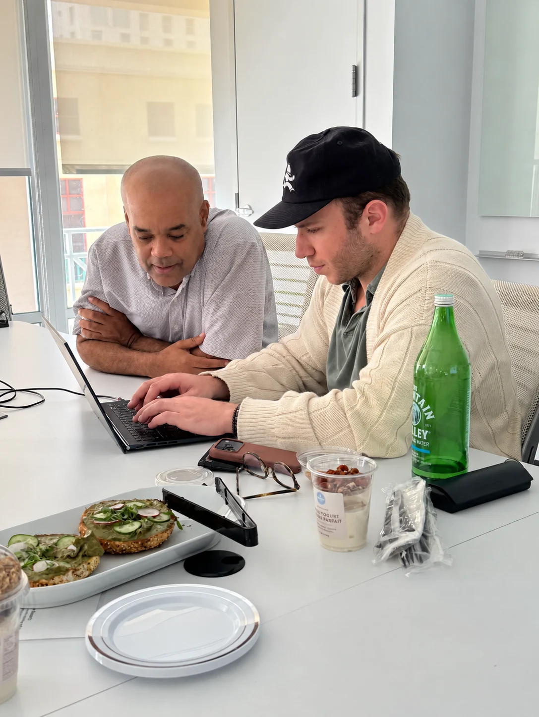 Two people working together at a laptop.